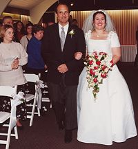 Donna and her dad walk up the aisle.