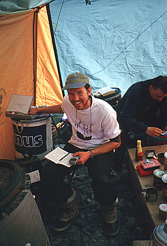 Eric Brown doing what he does best, reporting for PMA from Advanced Base Camp
	at 6,400 meters.  Witek is in the background playing his favorite game of 
	