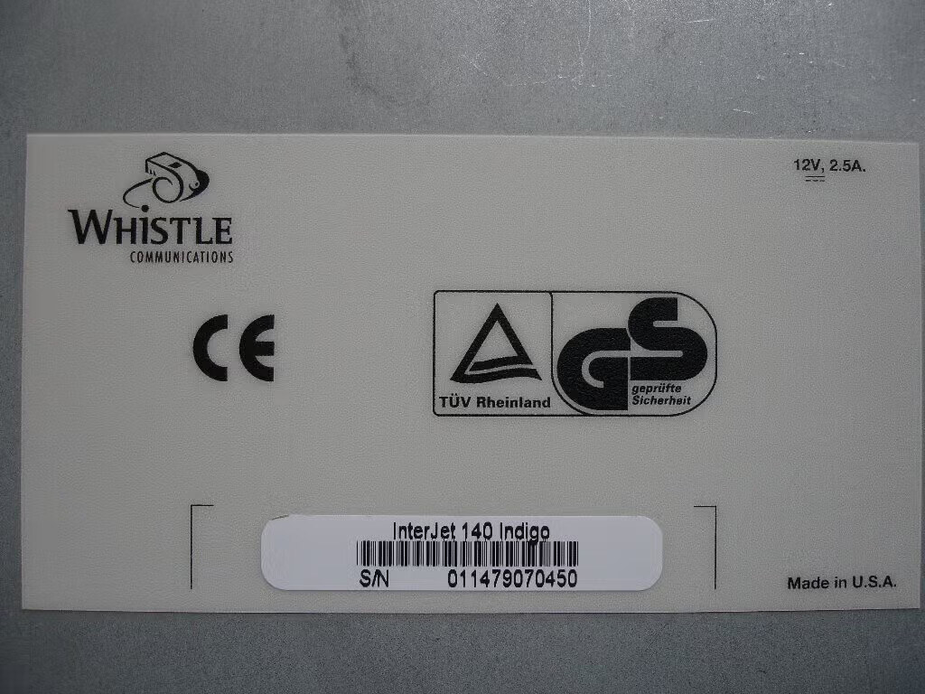 Bottom label of an InterJet 140 Indigo: S/N 011479070450, 12V 2.5A, CE and TUV Rheinland GS marks, Made in U.S.A.