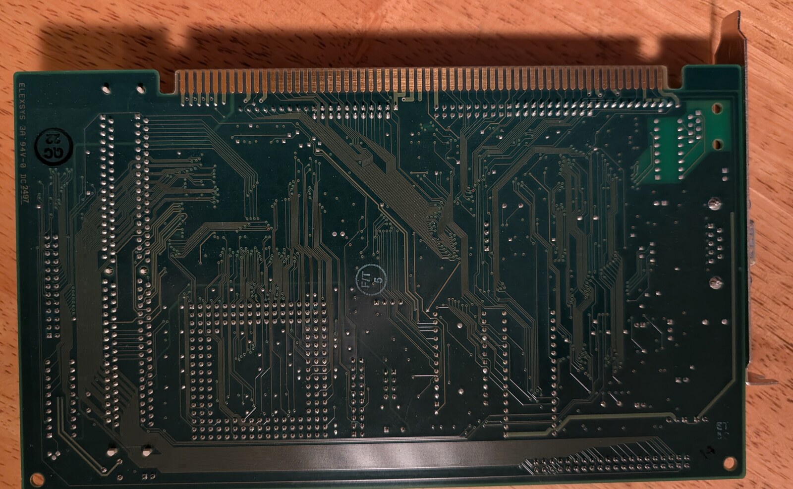 The mainboard's solder side. Its card edge has 60 contacts a side and no key notch: ISA's layout, with extra contacts where an ISA card has its notch and past its end.